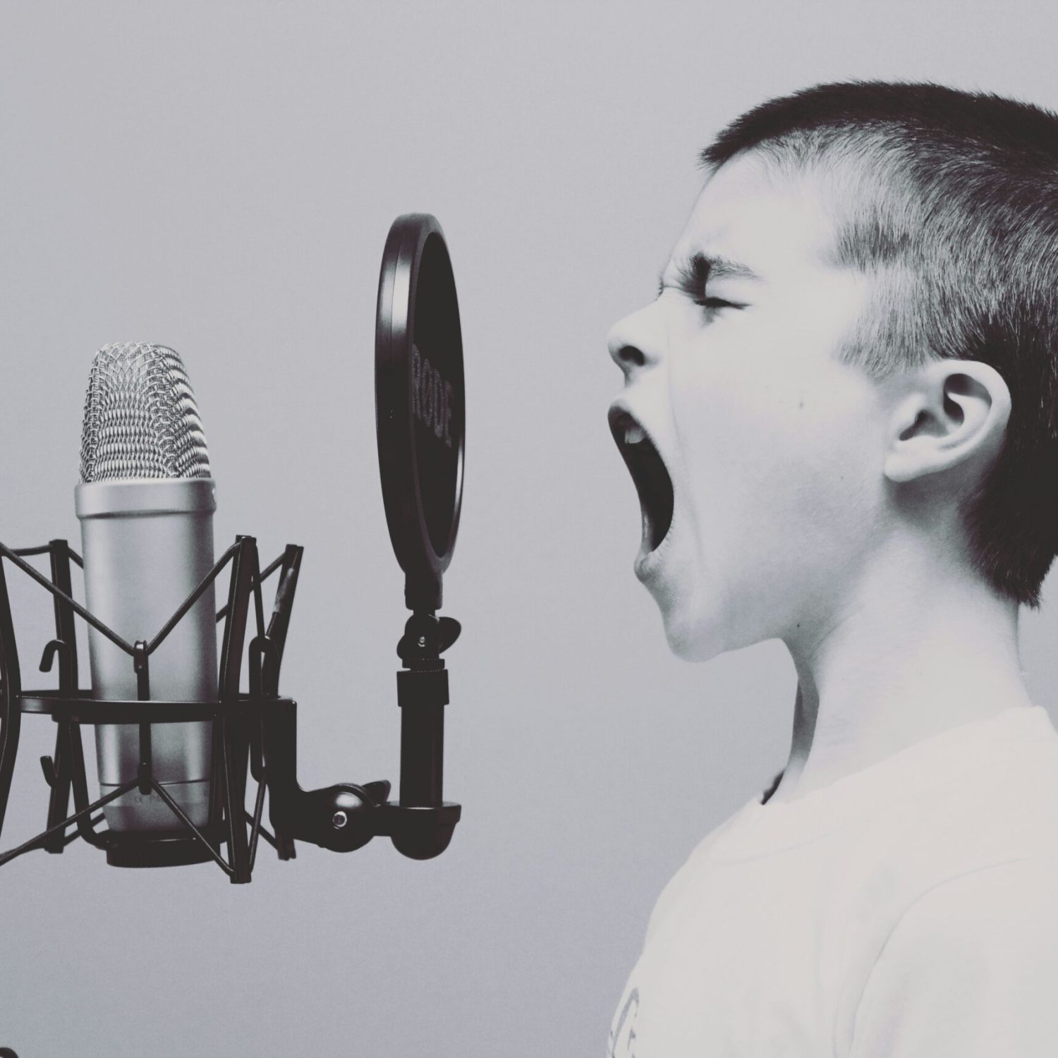 A kid screaming in front of a studio microphone